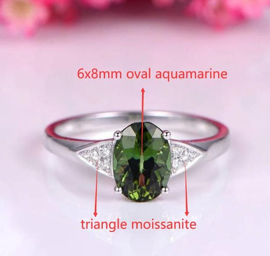 Custom order for Katie, main stone 6x8mm oval aquaamrine, triangle moissanite as the side stones, eagle claw, 14k white gold.