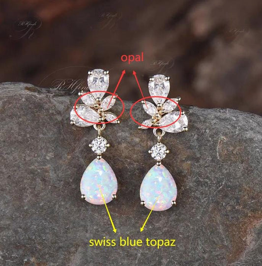Custom order for Kimi, main stone pear Swiss blue topaz, accent stones: pear and round moissanite, marquise opal, yellow gold plated.